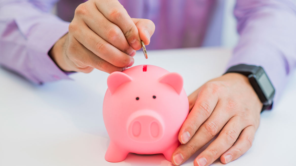 putting coin in piggy bank
