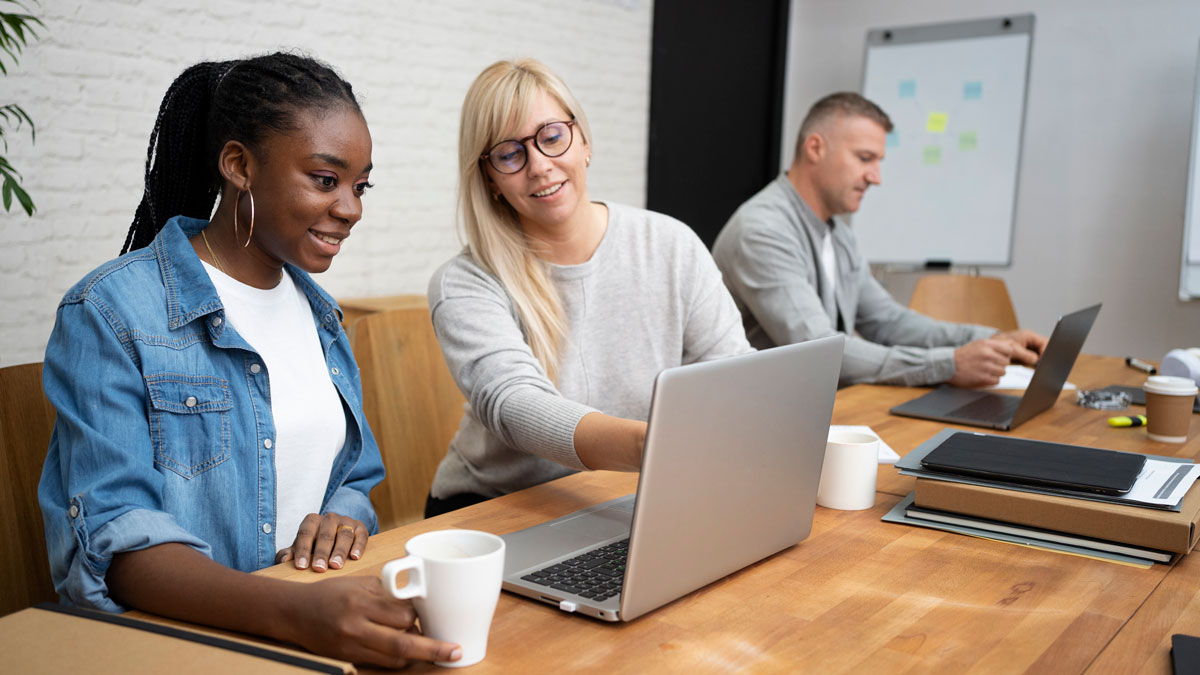 coworkers looking at laptop together