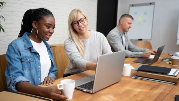 coworkers looking at laptop together