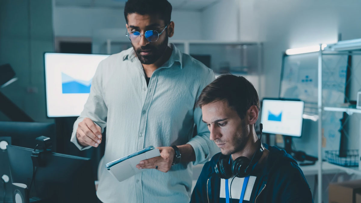 two men looking at computer