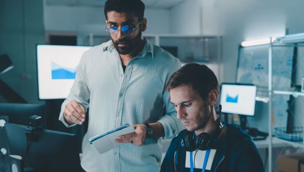 two men looking at computer